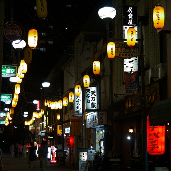 Nagasaki, street at night with lanterns near train station